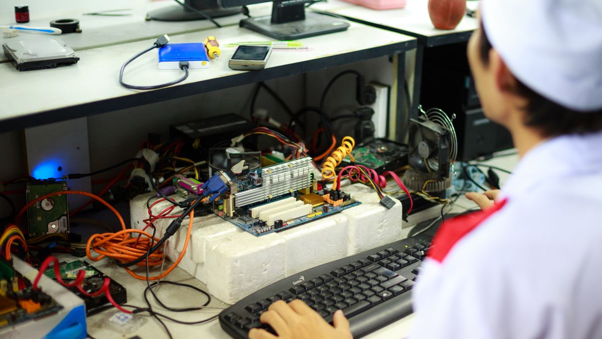 A software engineer working at a multi-monitor computer workstation